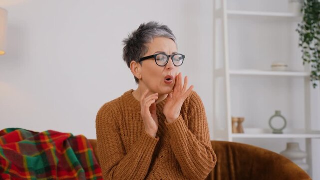 Senior woman suffering from sudden toothache pain