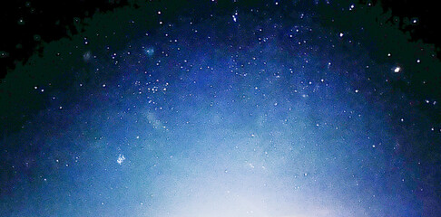 Fototapeta premium Night blue sky with bright light. Copy space