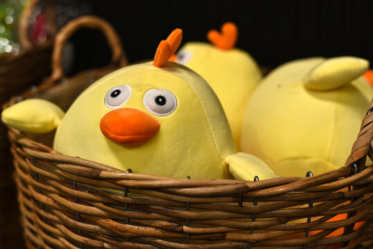 Easter holiday. Cute Easter chicks in a wicker basket at a decor store.
