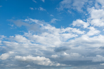 Fototapeta premium Blue sky with white clouds background, soft cloudy sky texture, sunny weather, natural atmosphere, minimal nature backdrop with copy space