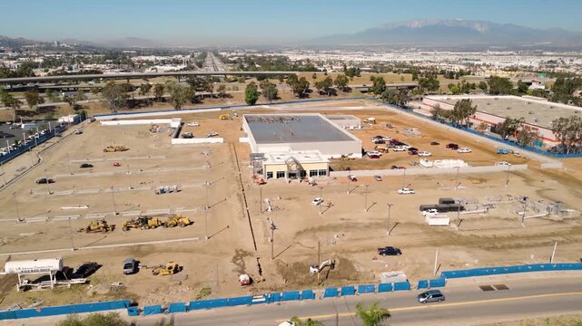 Aerial View of Automotive Dealership Construction Site with Steel Structure and Metal Roof