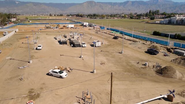 Aerial View of Automotive Dealership Construction Site with Steel Structure and Metal Roof