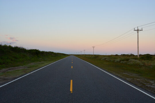 Sunrise on coastal highway Route 12, which runs through the sand dunes on the Outer Banks of North Carolina.