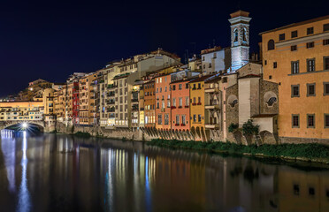 Fototapeta premium Cityscape with medieval gothic buildings on Arno River at night, Florence, Italy