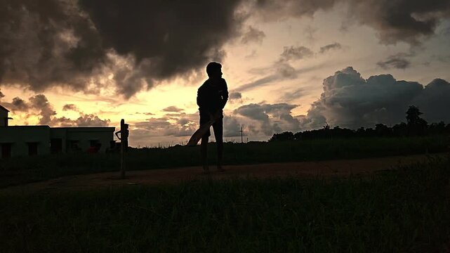 Cricket Player Silhouette Playing Shot at Sunset in India | Slow Motion Sports Scene