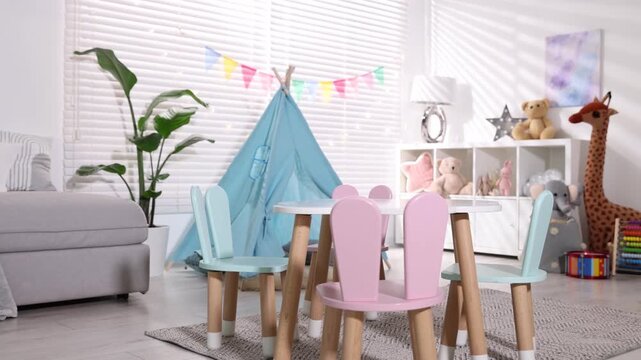 Child's room with furniture, toy wigwam, toys and colorful flags. Camera moving forward