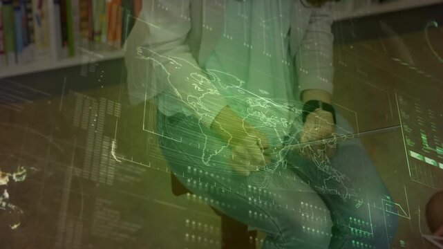 Woman guiding boy using laptop in learning hub, placing, tapping tablet, making green map shifting