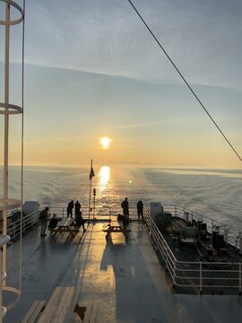 Ferry Deck at Sunrise in Bod&oslash;, Norway - Passengers Watching Golden Hour Over Sea
