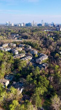 Vertical aerial drone shot over Chastain Park Golf Course toward Buckhead Atlanta 4K
