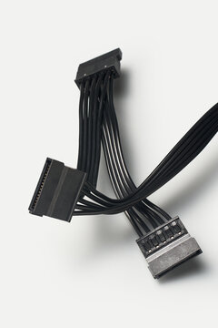 3 black sata power supply connectors with flat ribbon cables isolated gray background, internal computer hardware components for drive power, 