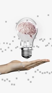 Right hand entering and steadying hovering brain bulb while gray pixels drifting, illustrating tech
