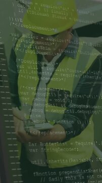 Vertical video: Plant worker tapping tablet, causing code overlay and checking chutes for safety
