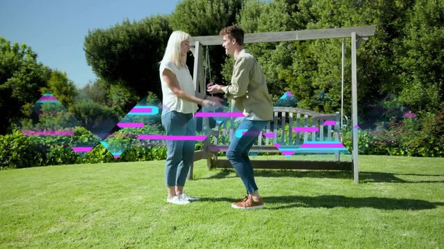 Man kneeling and proposing by swing, woman examining ring then embracing, tech glitching overlaying