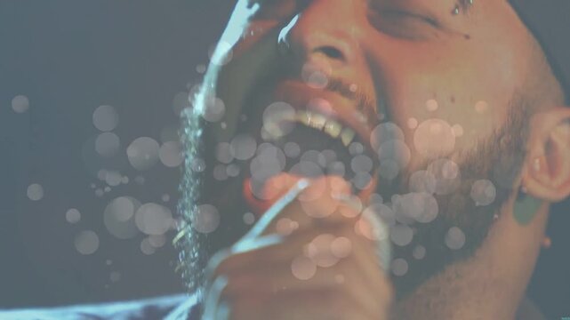 Vertical video: Overlay appearing, mid-adult singer belting song into mic in studio, wearing beanie