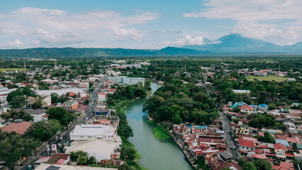 Aerial View of Santa Cruz River Cityscape in Laguna, Philippines, Tropical Town with Mountain Horizon and Lush Green Landscape © Gids Stories