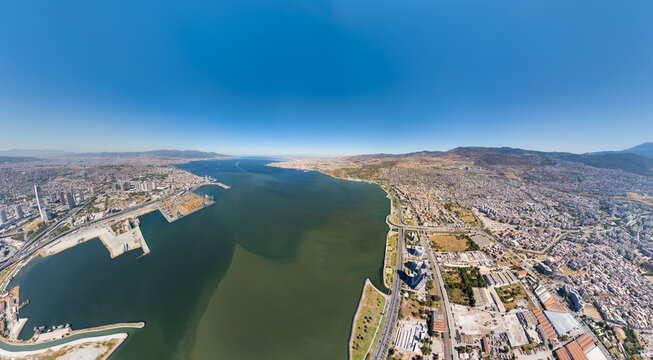 Izmir, Turkey. Aerial view of Izmir Bay with port, Bayrakli waterfront promenade, and rekreasyon alani recreation area. Bisikletli mola terasi and city skyline. Summer daytime. Aerial view.