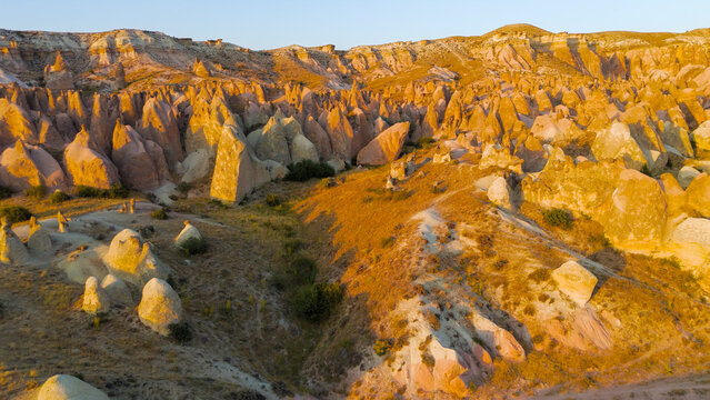Goreme, Nevsehir, Turkey. Evening aerial perspective of Devrent Valley highlighting geological diversity and mineral color variations at dusk.. Aerial View