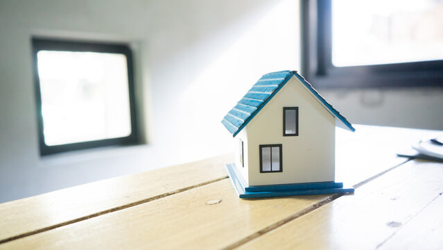 Real estate agents and clients are smiling and discussing property sales contracts, mortgages, investments, signing documents, purchase planning, ownership, and successful home sales transactions.