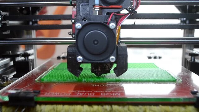 3D printer. 3D printer printing object close-up. 3D printer printing model green color. Working 3D printer. Concept printing technology. New modern additive progressive technology. FDM technologies