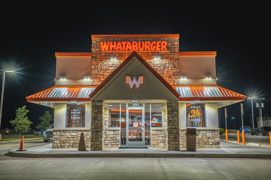 Lit Up Signs and Windows of Whataburger Restaurant and Empty Parking Lot at Night in Sweetwater, Texas