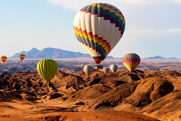 Obraz premium Hot Air Balloons Drifting Over Namibia’s Moon Valley During Golden Hour, Showcasing Breathtaking Views, Adventure, and the Magic of African Desert Scenery