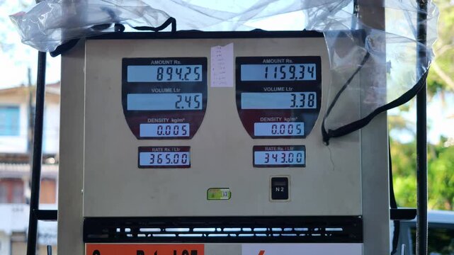 Close up of digital fuel pump display showing rising petrol prices, sale amount, volume in litres, and rate at gas station, illustrating global energy costs, economic inflation, transportation expense