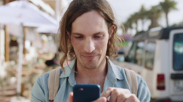 Happy man, phone and texting in city for travel with bag, funny chat and online dating in street. Person, smartphone and laugh with mobile app, backpack or notification on social media post in town