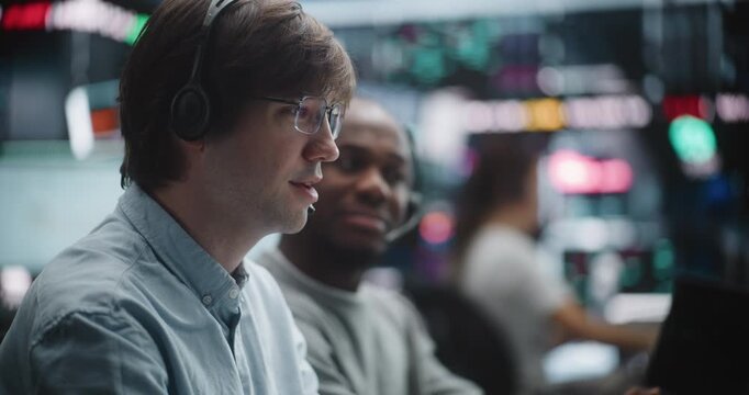 Senior Financial Advisor Evaluating Junior Analyst Practical Trading Skills. African American Senior Broker Observe Junior Specialist Working at Multi Monitor Dashboard. Professional Asset Management.