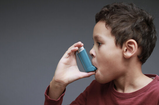 Asthma inhaler delivering fast, targeted relief to open airways and improve breathing during respiratory distress with people stock image stock photo