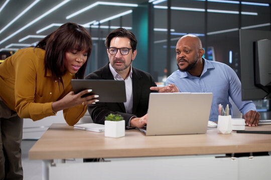 Financial Advisor And Marketing Analyst Review Data On Laptops During Teamwork
