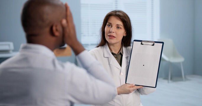 Doctor And Nurse Examine A Patients Sight Using A Laptop