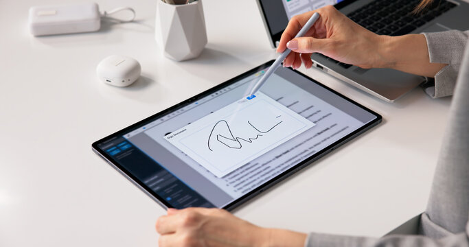 Business Professional Analyzing Electronic Agreements On Tablet Prior