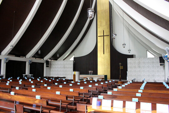 Modern church interior nave September Summer 2024 Wooden pews and curved ceiling beams Bangkok