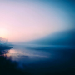 Fototapeta premium Small boat on calm misty lake with soft daylight and quiet shoreline backdrop