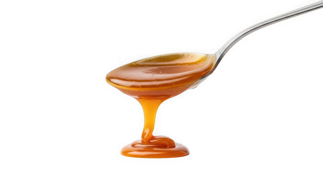 Golden syrup on a spoon with a small drizzle isolated on transparent background