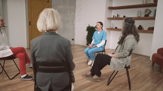 Group therapy for alcoholic anonymous, female psychologist speaking for women. Curing addiction and codependency, therapeutic talks with professional endocrinologist, asks of aging and mental health