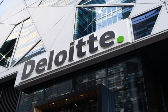 Deloitte branding on a contemporary corporate building, representing global professional services, consulting, and finance industries