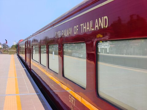 View of the Royal Blossom train at Suan Son Pradipat station platform under a clear blue sky on March 16, 2026 in Hua Hin, Thailand