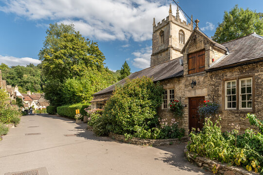 Historic stone weaver cottages along a narrow path in the village of Castle Combe, Cotswolds, England