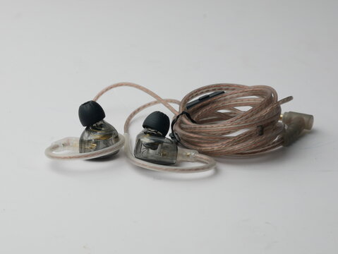 Close Up Detailed Earphone Audio Device with Cable on White Background