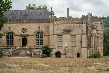 Obraz premium Exterior view of Lacock Abbey's south facade with its ornate windows and staircase, England