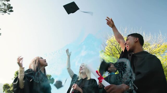 Vertical video: Blue powder sparking 4 grads in gowns to toss caps, celebrating grad on campus