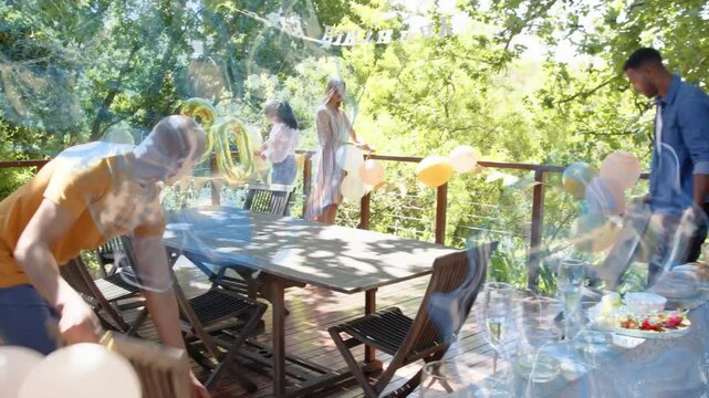 Approaching wooden table, group of four placing chairs and securing gold 30 balloons for birthday