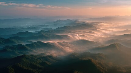 Fototapeta premium Breathtaking Aerial View of Serene Mountain Landscape with Mist and Soft Sunlight at Dawn Overrolling Hills and Valleys in Nature's Tranquil Beauty
