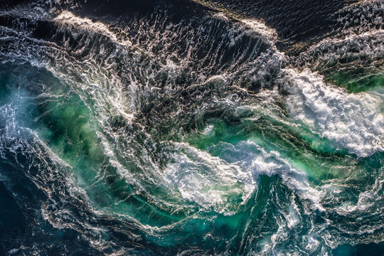Blue waves of water of the river and the sea meet each other during high tide and low tide.