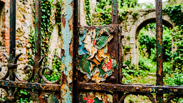 Rusty ornate garden gate, peeling paint