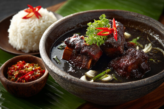 Authentic Iga Konro dish with grilled or cooked beef ribs in a thick, blackish broth.