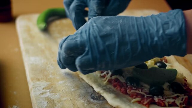 Pide with minced meat and cheese, edges being folded