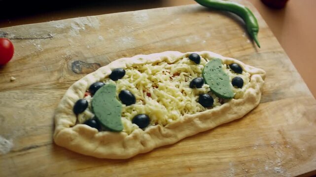 Minced meat and cheese pide ready to go into oven