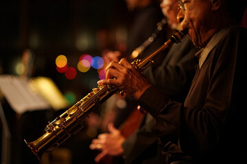 Fototapeta premium Jazz day musician plays saxophone on stage with sheet music
